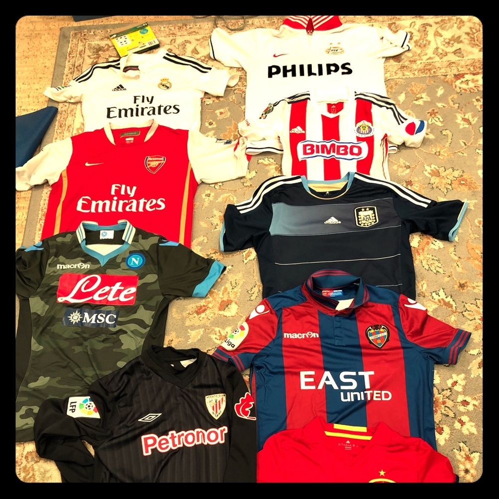 Lot of 9 soccer jerseys.